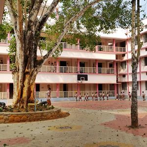 NVKS Higher Secondary School main buidling with play ground at front